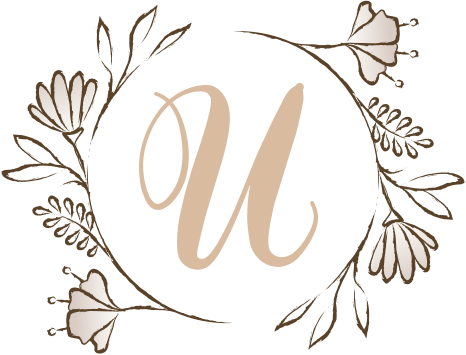 A letter U surrounded by laurel leaves